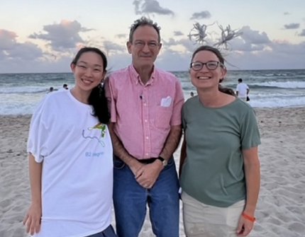 Freeman, Holland and a trainee smiling on the beach