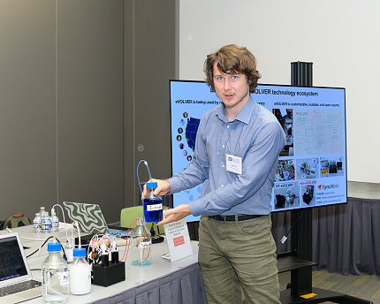 Hart holds up a scientific device