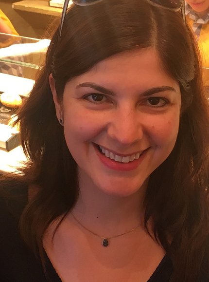 Cristea, pictured against illuminated bakery shelves.