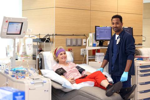 Donor reclines alongside tech.