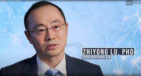 Image of Lu against a light blue background. A graphic bearing his name is positioned above his left shoulder.