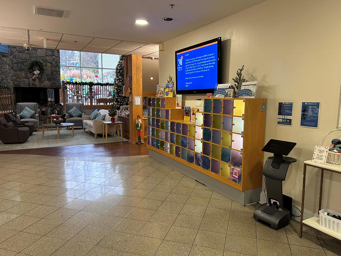 An open room with a row of shelves along the right wall. The shelves contain rows of small compartments, which serve as mailboxes.