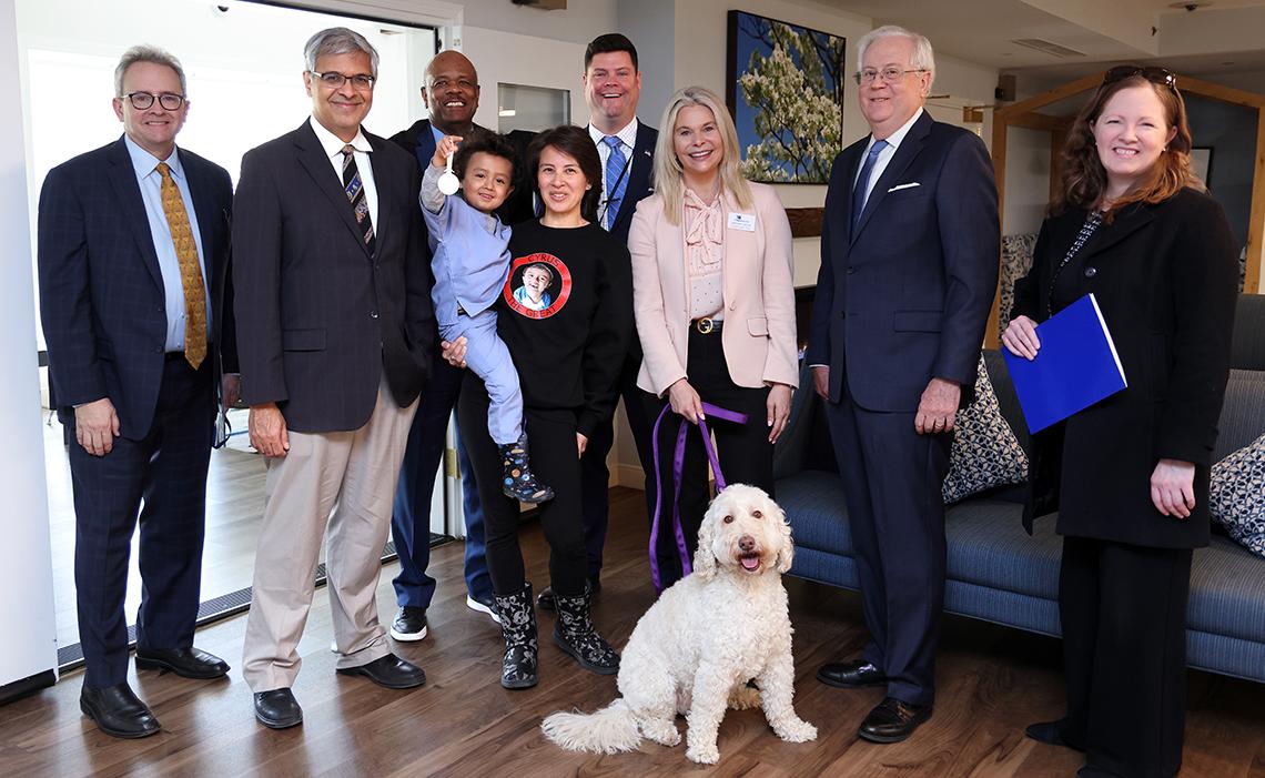 VIP group with Zilly the pup pose in the Children's Inn.