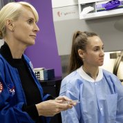 Rubins and a scientist in a blue coat look out of the frame.